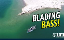 Blading bass headline boat in the middle of the water drone shot