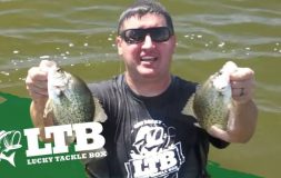 Man holding fish in each hand standing in the water