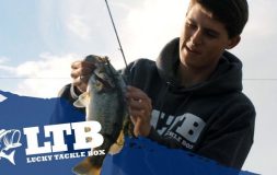 Man looking at fish holding it with both hands