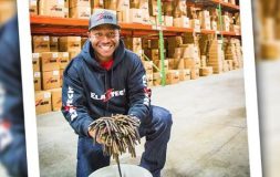 Man smiling holding stripes in the factory