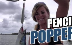 Woman holding pencil popper and fish