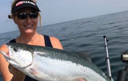 Woman with livetarget hat holding trout